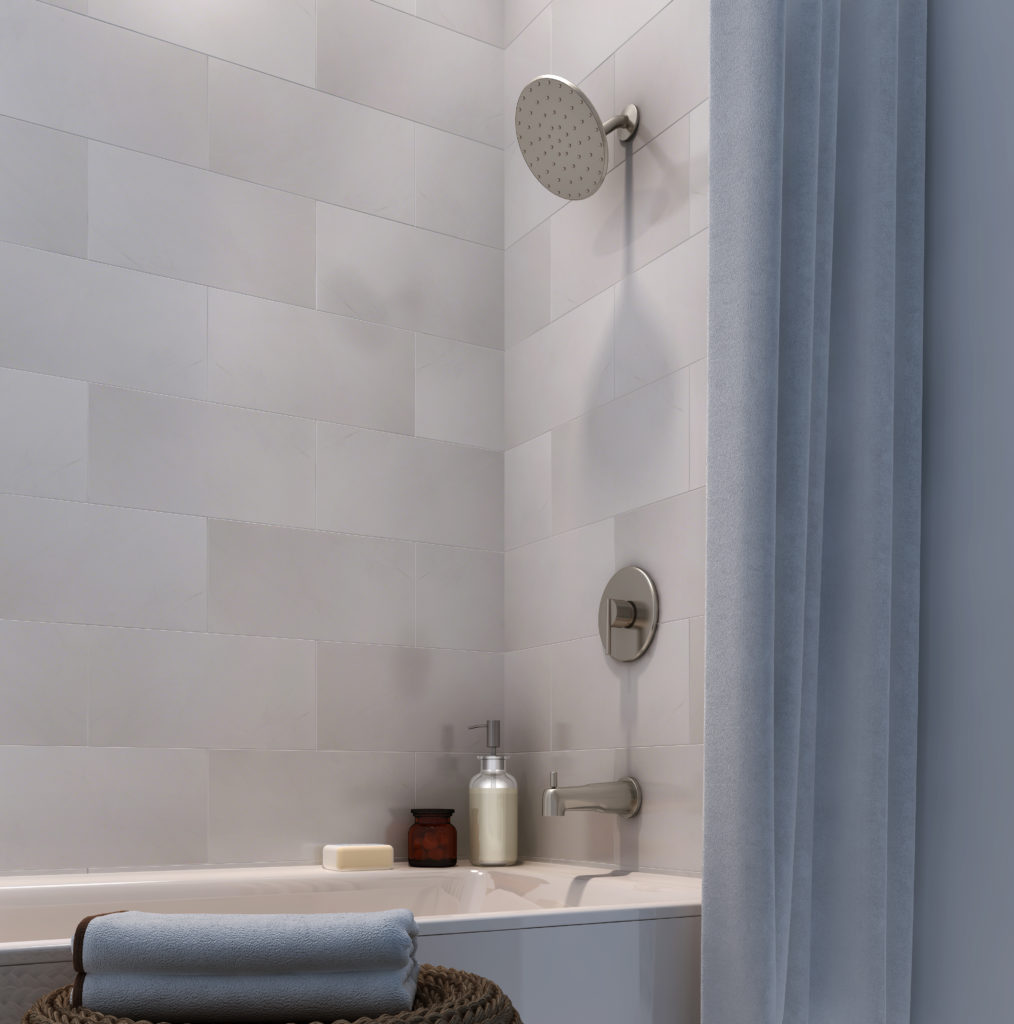 This shower design has a light tan tiled wall with dark silver fixtures. There is a blue shower curtain pulled back, along with blue towels, soap and bottle incorporated in the image.