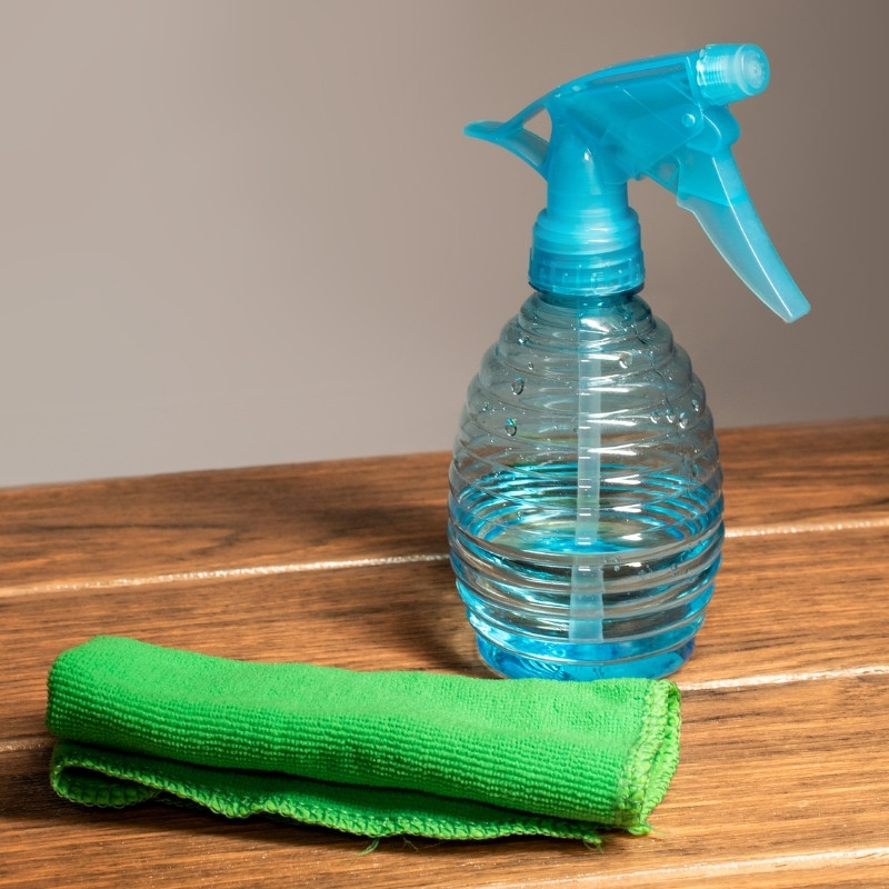 A microfiber cleaning cloth with a plastic spray bottle