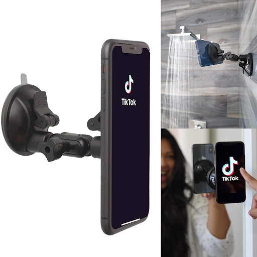 There is one black phone holder stuck to the shower wall and one to the bathroom mirror. A person is touching the phone screen which says TikTok.