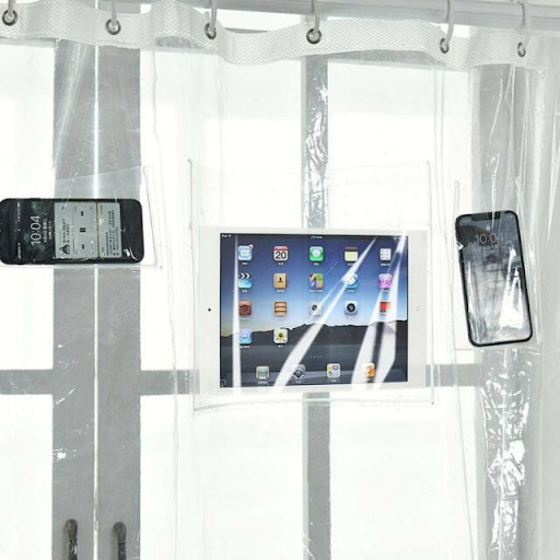 A clear shower liner has pockets to store devices. There are two phones and a white tablet being held by this shower liner.